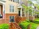Inviting townhome entrance with brick stairs, black railings, and landscaped garden at 815 Granby Dr, Fort Mill, SC 29708