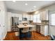 Modern kitchen with stainless steel appliances, wooden floors, and island with seating at 815 Granby Dr, Fort Mill, SC 29708