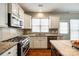 Kitchen with stainless steel oven and microwave, stone counter tops, and kitchen island at 815 Granby Dr, Fort Mill, SC 29708