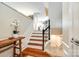 Elegant staircase with hardwood steps, white risers, and wrought iron railing at 815 Granby Dr, Fort Mill, SC 29708
