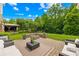 Spacious backyard with a patio, fire pit, and lush green lawn at 8460 Fairgreen Ave, Waxhaw, NC 28173
