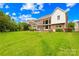 Green backyard with established trees, patio, and swing set area at 8460 Fairgreen Ave, Waxhaw, NC 28173