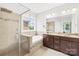 Luxurious bathroom with a walk-in shower, soaking tub, and double vanity at 8460 Fairgreen Ave, Waxhaw, NC 28173