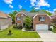 Beautiful two-story brick home with a manicured lawn and an attached two-car garage at 8460 Fairgreen Ave, Waxhaw, NC 28173