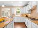 Bright kitchen with granite countertops, stainless steel appliances, and hardwood floors at 8460 Fairgreen Ave, Waxhaw, NC 28173