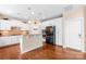 Well-lit kitchen featuring white cabinets, a breakfast bar, and stainless steel appliances at 8460 Fairgreen Ave, Waxhaw, NC 28173