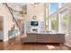 Bright living room with tall windows, hardwood floors, fireplace, and built-in shelving at 8460 Fairgreen Ave, Waxhaw, NC 28173