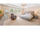 Main bedroom with tray ceilings, large windows, and a comfortable seating area at 8460 Fairgreen Ave, Waxhaw, NC 28173