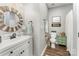 Charming powder room featuring a vanity with a decorative mirror and a wooden cabinet at 915 Northeast Dr # 15, Davidson, NC 28036