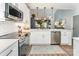 Open-concept kitchen with white cabinetry, stainless steel appliances, and stylish pendant lighting at 915 Northeast Dr # 15, Davidson, NC 28036