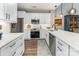 Modern white kitchen with stainless steel appliances, quartz countertops, and subway tile backsplash at 915 Northeast Dr # 15, Davidson, NC 28036