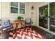 Cozy patio seating area with patterned cushions, table, and red and white patterned rug at 915 Northeast Dr # 15, Davidson, NC 28036