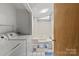 Well-lit bathroom featuring shower-tub combo, washer and dryer, and tile flooring at 935 Church St, Kings Mountain, NC 28086