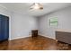 Well-lit bedroom featuring hardwood floors, neutral paint, a ceiling fan, and a large window at 935 Church St, Kings Mountain, NC 28086