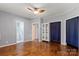 Bedroom with hardwood floors, ceiling fan, and white armoire storage at 935 Church St, Kings Mountain, NC 28086