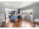 Dining area with hardwood floors and a bay window, adjacent to an open kitchen with blue cabinetry at 935 Church St, Kings Mountain, NC 28086