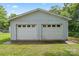 Two-car detached garage with white doors on a well-kept green lawn at 935 Church St, Kings Mountain, NC 28086