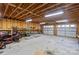 Spacious garage with exposed wooden beams and two-car door, offering ample storage and workspace at 935 Church St, Kings Mountain, NC 28086