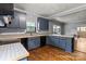 Bright kitchen featuring blue cabinets, butcher block countertops, and a view into the connected living space at 935 Church St, Kings Mountain, NC 28086