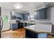 Cozy kitchen showcasing blue cabinets, butcher block countertops, tile backsplash, and modern appliances at 935 Church St, Kings Mountain, NC 28086