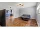 Open living room with hardwood floors, ceiling fan, gray walls, and view of kitchen with island at 935 Church St, Kings Mountain, NC 28086