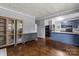 Open-concept space featuring hardwood floors, gray walls, built in storage, and a blue island kitchen at 935 Church St, Kings Mountain, NC 28086