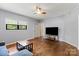 Spacious living room with hardwood floors, gray walls, ceiling fan and tv at 935 Church St, Kings Mountain, NC 28086