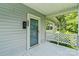 Inviting porch with lattice railing leading to a front door with sidelight and view of trees at 935 Church St, Kings Mountain, NC 28086