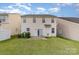Back exterior featuring siding, a patio, and a spacious lawn with a privacy fence at 9630 Turning Wheel Dr, Charlotte, NC 28214