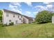 Large backyard with green grass offers great space and a private outdoor escape at 9630 Turning Wheel Dr, Charlotte, NC 28214