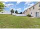 Spacious backyard showcasing green grass and a white privacy fence offers outdoor enjoyment at 9630 Turning Wheel Dr, Charlotte, NC 28214