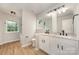 Full bathroom showcasing double sinks, soaking tub, tile floors and bright natural light at 9630 Turning Wheel Dr, Charlotte, NC 28214