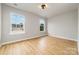 Bright bedroom featuring wood-look flooring, neutral walls and a contemporary ceiling light fixture at 9630 Turning Wheel Dr, Charlotte, NC 28214