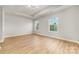 Bright bedroom with two windows, trey ceiling and wood-look floors offer natural light at 9630 Turning Wheel Dr, Charlotte, NC 28214