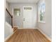 Bright entryway with wood floors, white door, and staircase at 9630 Turning Wheel Dr, Charlotte, NC 28214