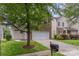 Charming two-story home featuring a brick and siding facade, attached garage and manicured lawn at 9630 Turning Wheel Dr, Charlotte, NC 28214