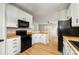 Modern kitchen featuring white cabinets, wooden counters, and new black appliances at 9630 Turning Wheel Dr, Charlotte, NC 28214