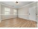 Well-lit living room featuring new luxury vinyl flooring, fresh paint, and updated trim at 9630 Turning Wheel Dr, Charlotte, NC 28214