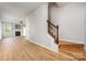 Open living room with wood floors, fireplace, and staircase at 9630 Turning Wheel Dr, Charlotte, NC 28214