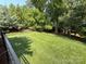 Well-maintained backyard with lush green grass and mature landscaping at 11324 Fullerton Place Nw Dr, Huntersville, NC 28078