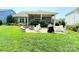 Backyard boasts a stone patio with a built-in fire pit, perfect for outdoor gatherings at 11324 Fullerton Place Nw Dr, Huntersville, NC 28078