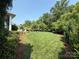 Large, well-maintained backyard with lush green grass and mature landscaping at 11324 Fullerton Place Nw Dr, Huntersville, NC 28078