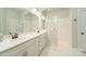 Bathroom featuring marble countertops, dual sinks, and a glass-enclosed shower at 11324 Fullerton Place Nw Dr, Huntersville, NC 28078