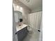Charming bathroom with floral wallpaper, updated vanity, tub, and shower at 11324 Fullerton Place Nw Dr, Huntersville, NC 28078