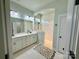 Elegant bathroom with double sinks, white cabinets, and a glass-enclosed shower with tile surround at 11324 Fullerton Place Nw Dr, Huntersville, NC 28078