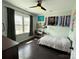 Cozy bedroom with a ceiling fan, natural light, and dark wood flooring at 11324 Fullerton Place Nw Dr, Huntersville, NC 28078