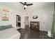 Bedroom featuring wood floors, ceiling fan and bathroom access at 11324 Fullerton Place Nw Dr, Huntersville, NC 28078