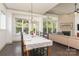 Open dining area with large windows, elegant chandelier, and hardwood floors at 11324 Fullerton Place Nw Dr, Huntersville, NC 28078