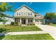 Inviting two-story home with a charming front porch, manicured lawn, and attached two-car garage at 11324 Fullerton Place Nw Dr, Huntersville, NC 28078