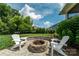Charming fire pit area featuring a stone surround, patio, and cozy seating perfect for outdoor relaxation at 11324 Fullerton Place Nw Dr, Huntersville, NC 28078